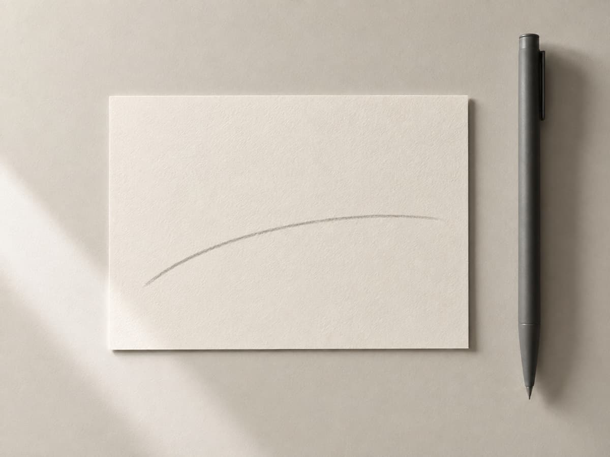 A blank card and a pen on a pale surface